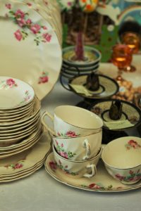 Beautiful porcelain crockery with floral design showcased at a market stall.